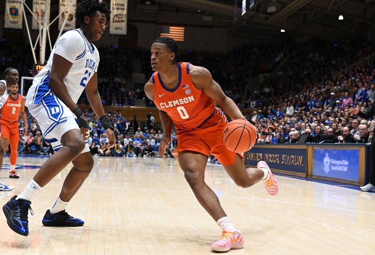 Feb 14, 2026; Durham, North Carolina, USA; Clemson Tigers forward RJ Godfrey (0) drives to the basket during the first half against the Duke Blue Devils center Patrick Ngongba II (21) at Cameron Indoor Stadium. Mandatory Credit: Rob Kinnan-Imagn Images