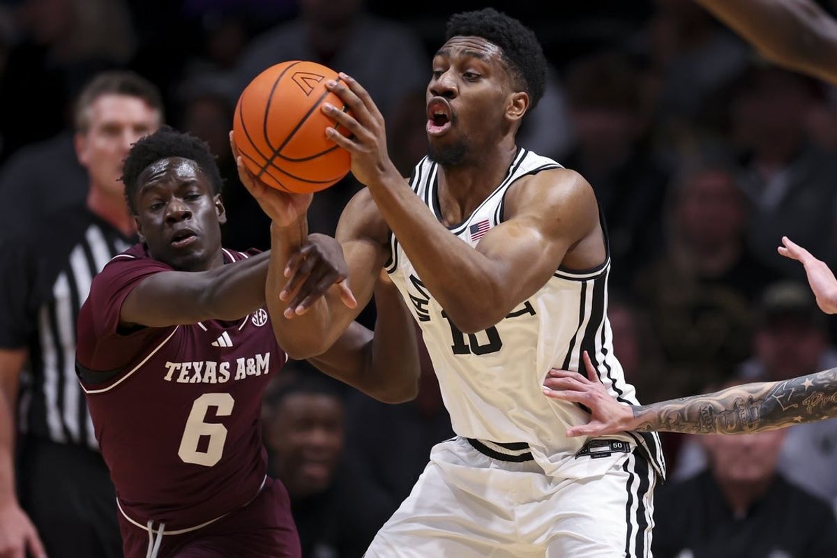 Feb 14, 2026; Nashville, Tennessee, USA; Texas A&M Aggies guard Ali Dibba (6) fouls Vanderbilt Commodores forward Ak Okereke (10) during the first half at Memorial Gymnasium. Mandatory Credit: Steve Roberts-Imagn Images