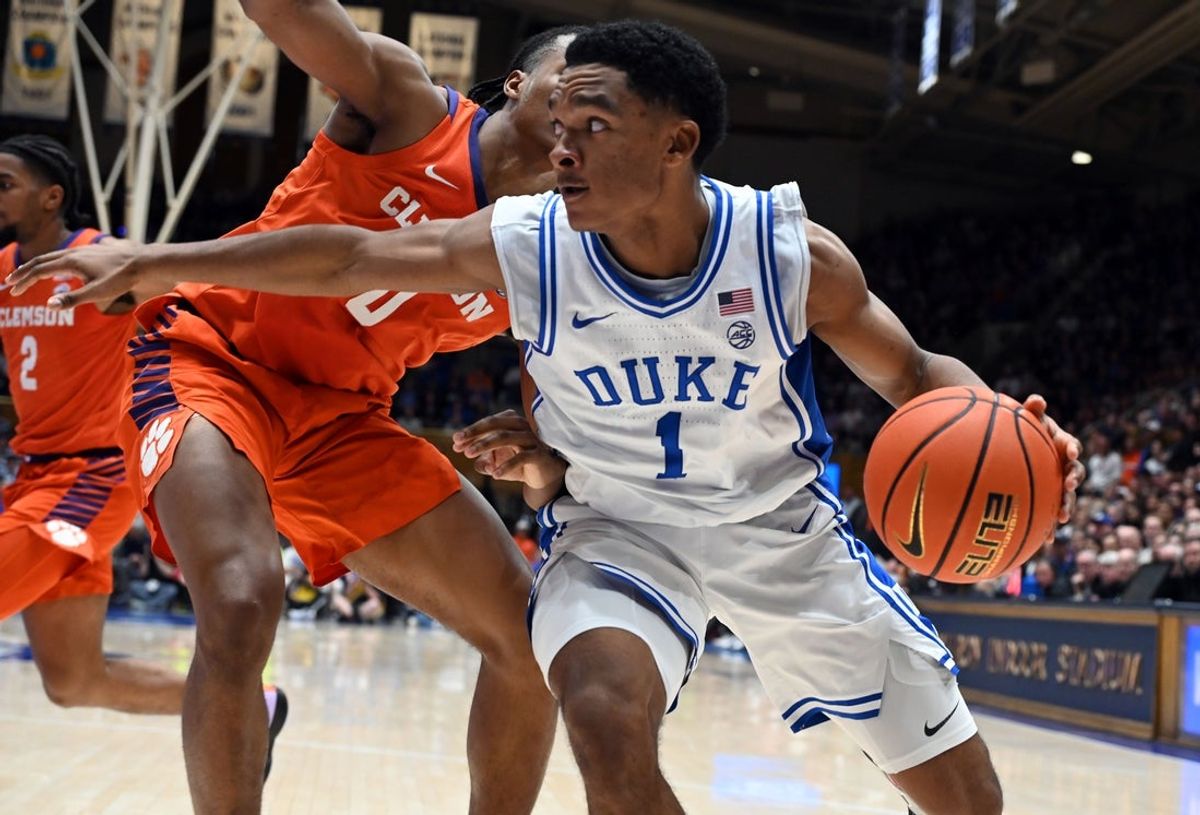 Feb 14, 2026; Durham, North Carolina, USA; Duke Blue Devils guard Caleb Foster (1) controls the ball in front of Clemson Tigers forward RJ Godfrey (0) during the second half at Cameron Indoor Stadium. Mandatory Credit: Rob Kinnan-Imagn Images
