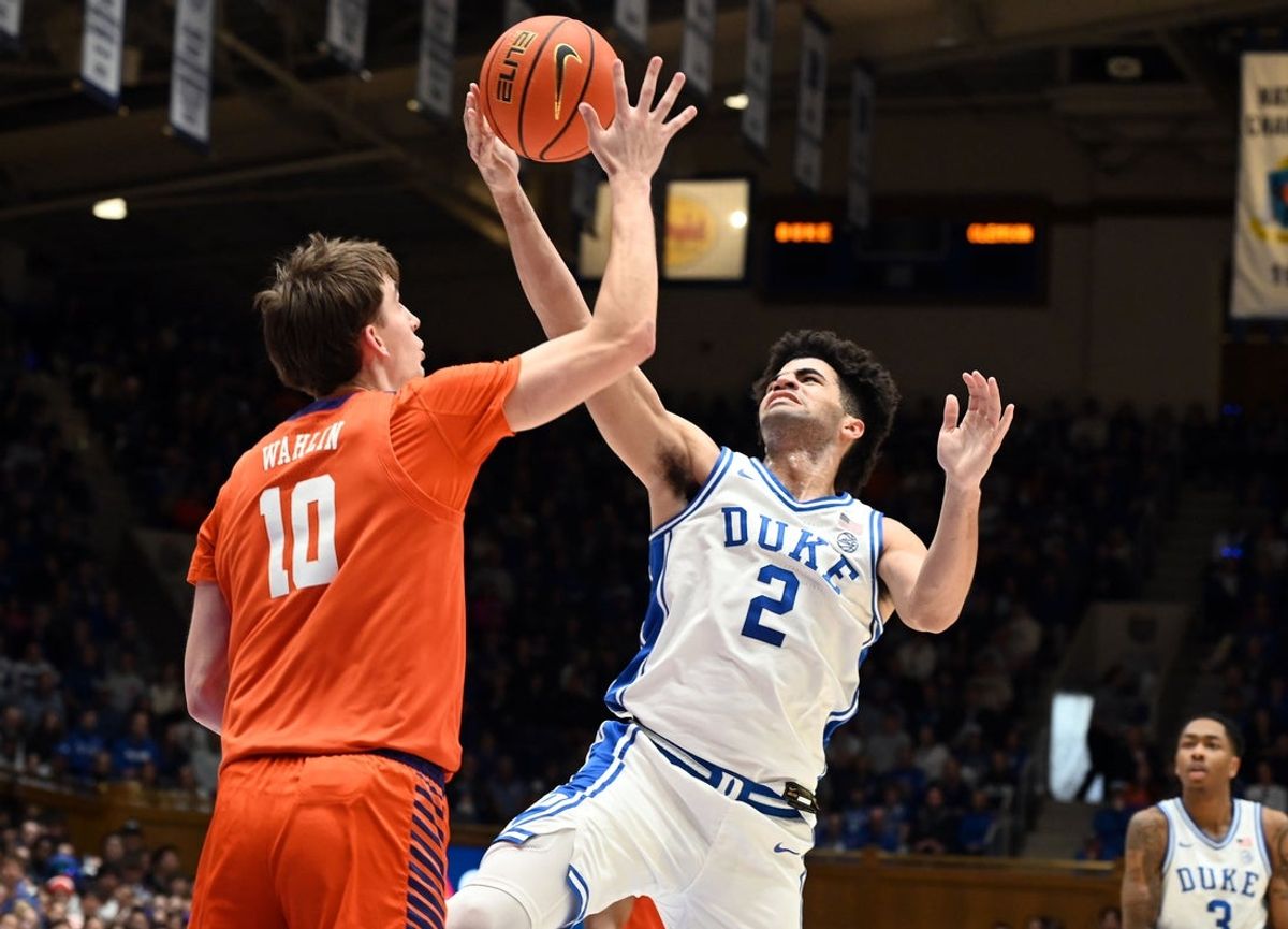 Feb 14, 2026; Durham, North Carolina, USA; Duke Blue Devils guard Cayden Boozer (2) lays the ball up over Clemson Tigers forward Jake Whalin (10) during the second half at Cameron Indoor Stadium. Mandatory Credit: Rob Kinnan-Imagn Images