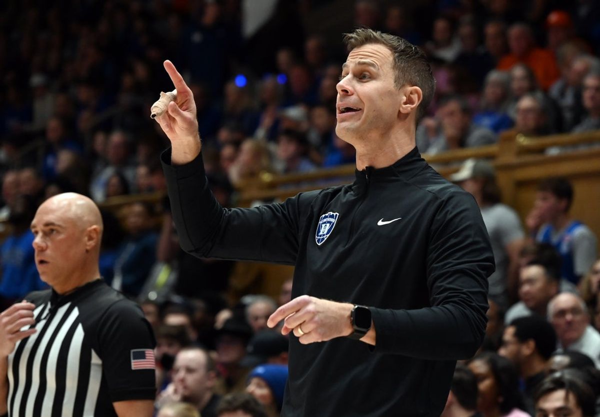 Feb 14, 2026; Durham, North Carolina, USA; Duke Blue Devils head coach Jon Scheyer (right) directs his team  during the second half against the Clemson Tigers at Cameron Indoor Stadium. Mandatory Credit: Rob Kinnan-Imagn Images