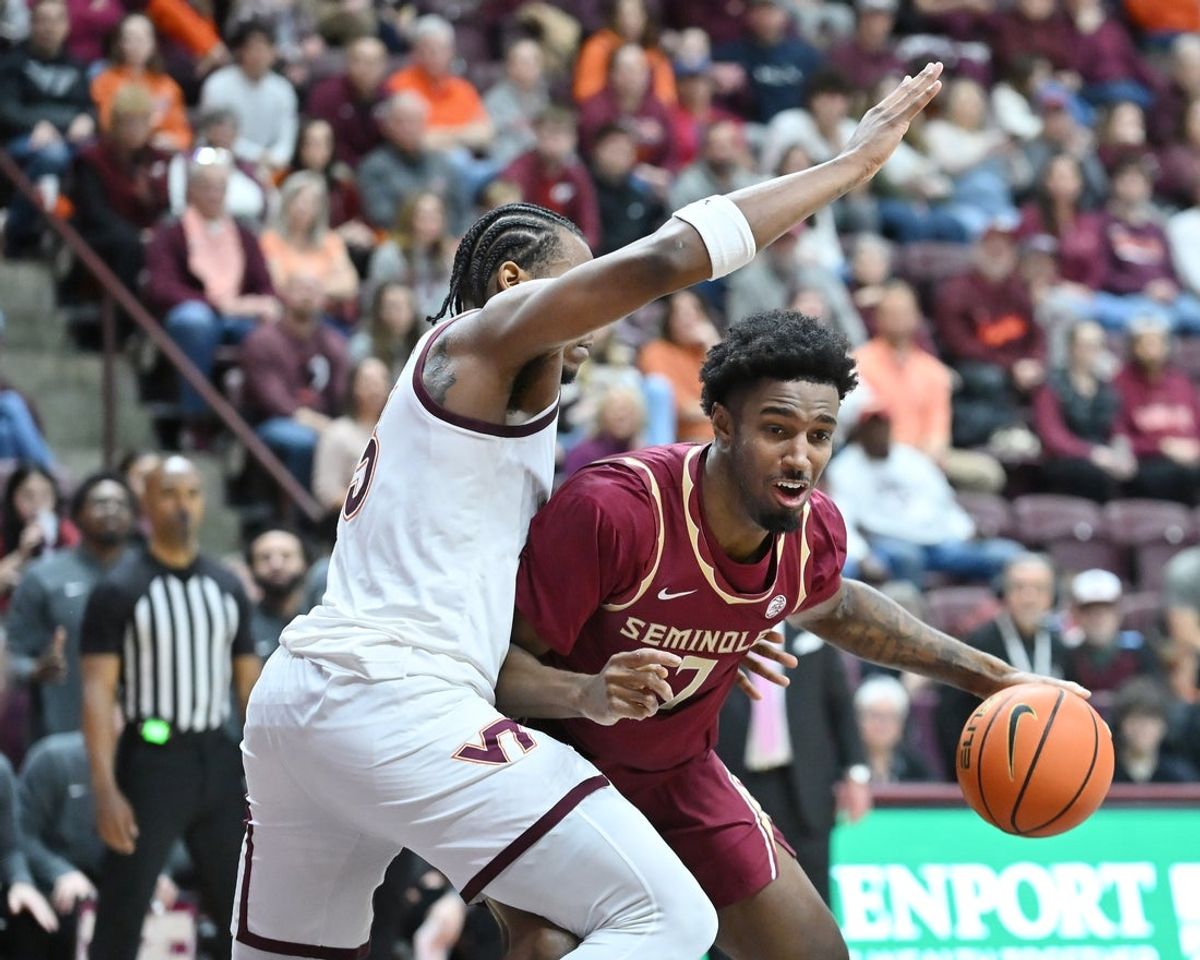 Feb 14, 2026; Blacksburg, Virginia, USA;  Florida State Seminoles forward Chauncey Wiggins (7) dribbles against Virginia Tech Hokies forward Amani Hansberry (13) during the first half at Cassell Coliseum. Mandatory Credit: Brian Bishop-Imagn Images