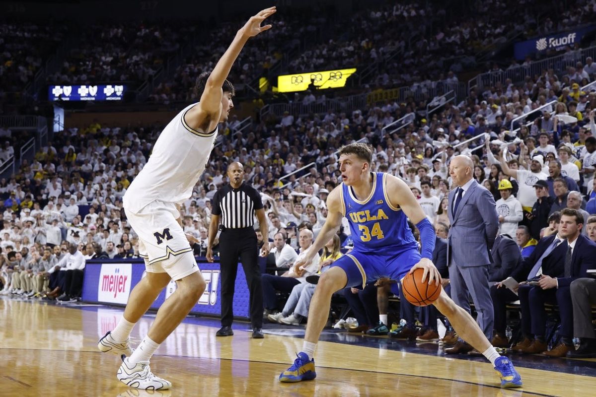Feb 14, 2026; Ann Arbor, Michigan, USA; UCLA Bruins forward Tyler Bilodeau (34) is defended by Michigan Wolverines center Aday Mara (15) in the second half at Crisler Center. Mandatory Credit: Rick Osentoski-Imagn Images