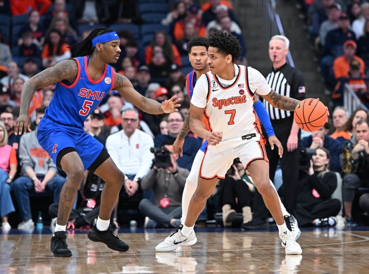 Feb 14, 2026; Syracuse, New York, USA; Syracuse Orange forward Kiyan Anthony (7) looks to get the ball past Southern Methodist University Mustangs guard Jaron Pierre Jr. (5) in the first half  at the JMA Wireless Dome. Mandatory Credit: Mark Konezny-Imagn Images