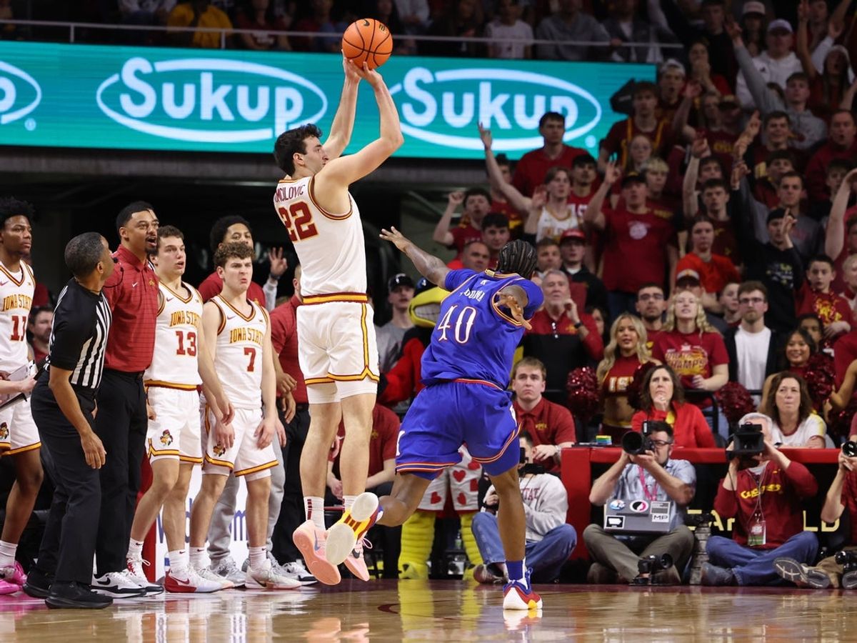 Feb 14, 2026; Ames, Iowa, USA;  Iowa State Cyclones forward Milan Momcilovic (22) shoots over Kansas Jayhawks forward Flory Bidunga (40) during the second half at James H. Hilton Coliseum. Mandatory Credit: Reese Strickland-Imagn Images