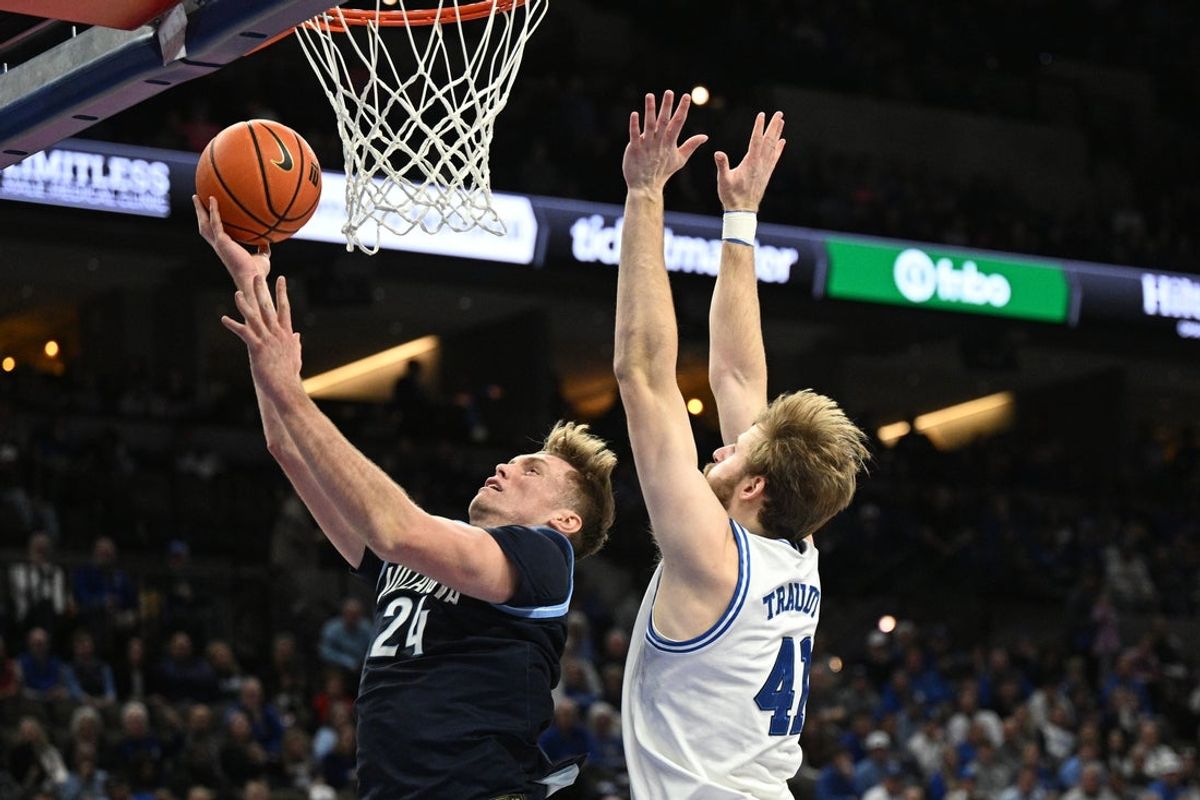 Feb 14, 2026; Omaha, Nebraska, USA;  Villanova Wildcats forward Duke Brennan (24) drives against Creighton Bluejays forward Isaac Traudt (41) during the first half at CHI Health Center Omaha. Mandatory Credit: Steven Branscombe-Imagn Images