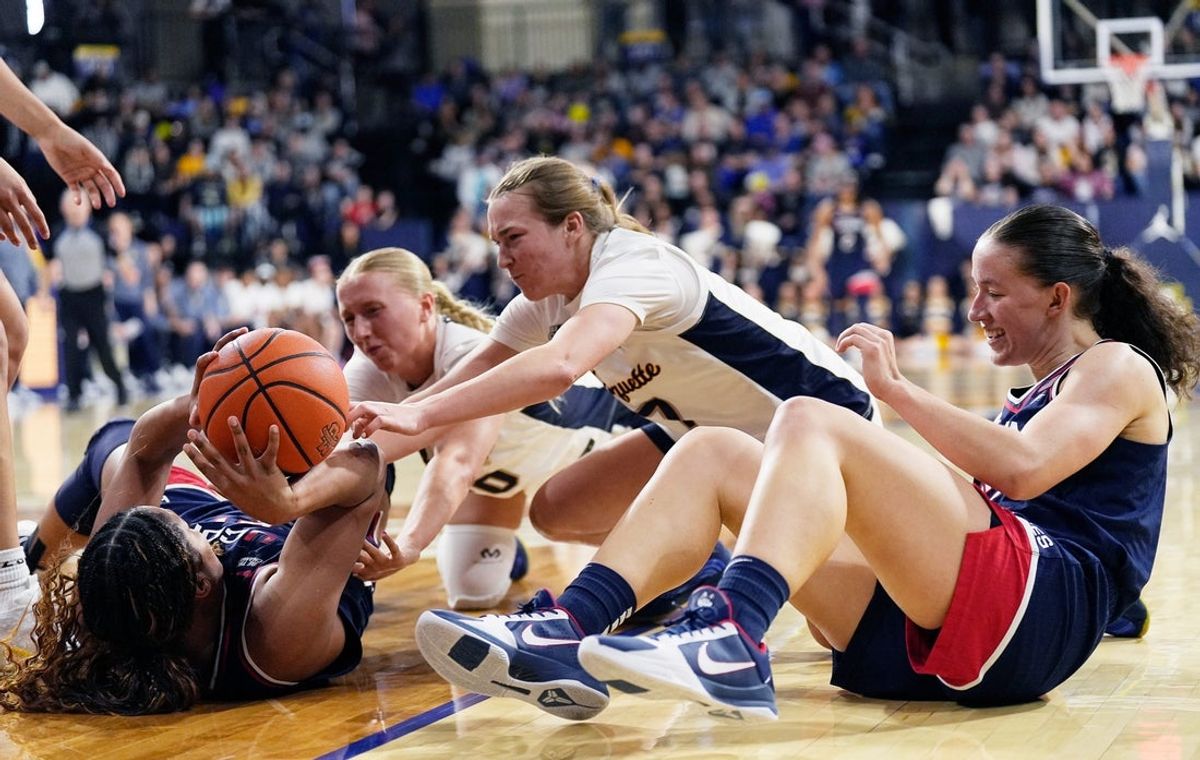 Marquette Golden Eagles guard Jordan Meulemans (20) and guard Bridget Utberg (7) fights for position against UConn Huskies forward Sarah Strong (21) and guard Ashlynn Shade (12) during the fourth quarter of the game on Saturday February 14, 2026 at the Al McGuire Center in Milwaukee, Wisconsin.