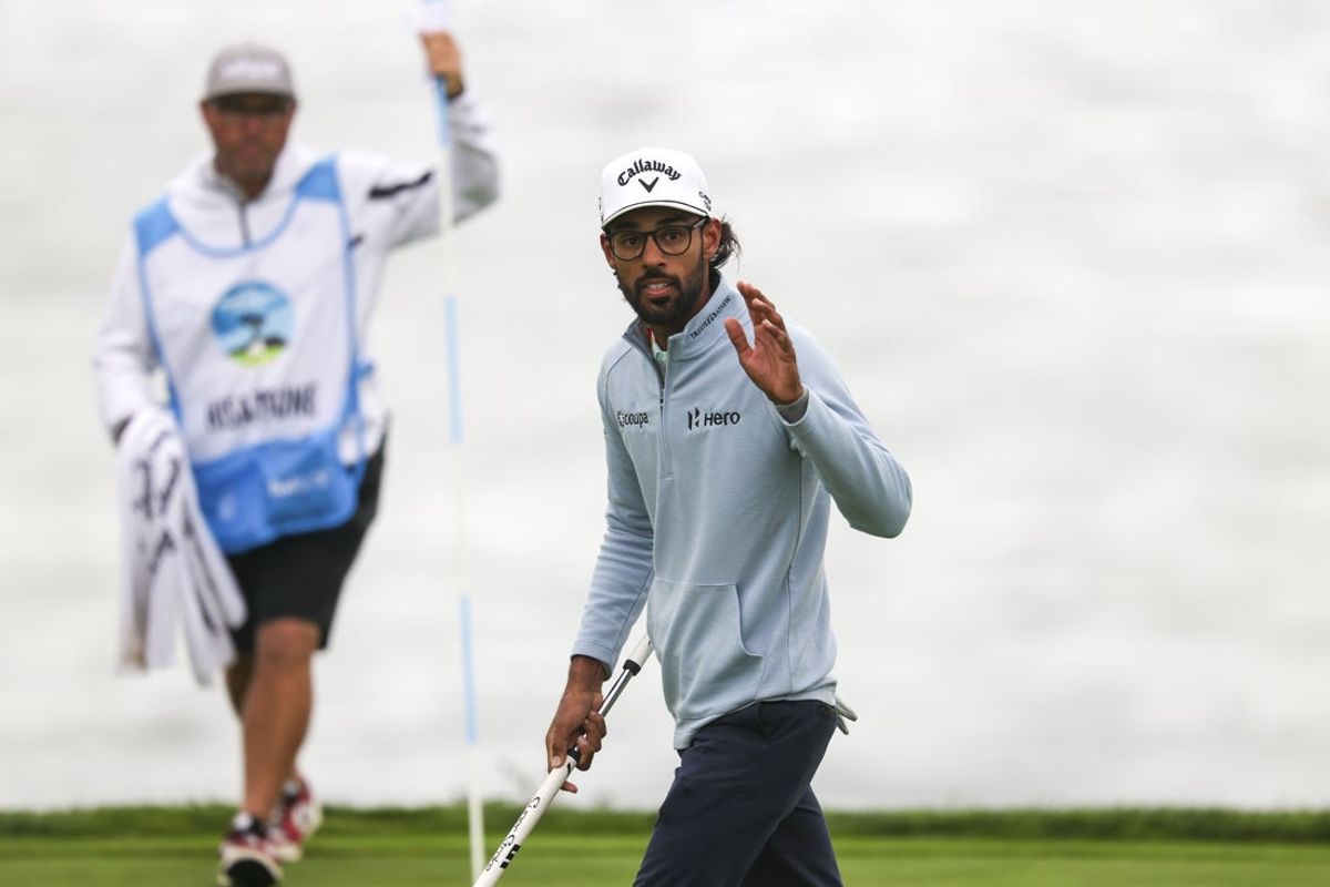 Feb 14, 2026; Pebble Beach, California, USA; Akshay Bhatia acknowledges the crowd after making his putt on the fifth hole during the third round of the AT&T Pebble Beach Pro-Am golf tournament at Pebble Beach Golf Links. Mandatory Credit: Kiyoshi Mio-Imagn Images