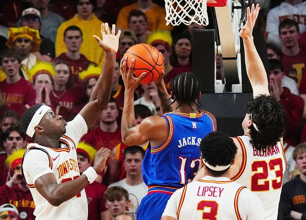 Iowa State Cyclones forward Killyan Toure (27) and Iowa State Cyclones forward Blake Buchanan (23) defends as Kansas Jayhawks guard Elmarko Jackson (13) drives to the basket during the second half in the Big-12 conference basketball showdown on Feb. 14, 2026, at Hilton Coliseum, in Ames, Iowa.