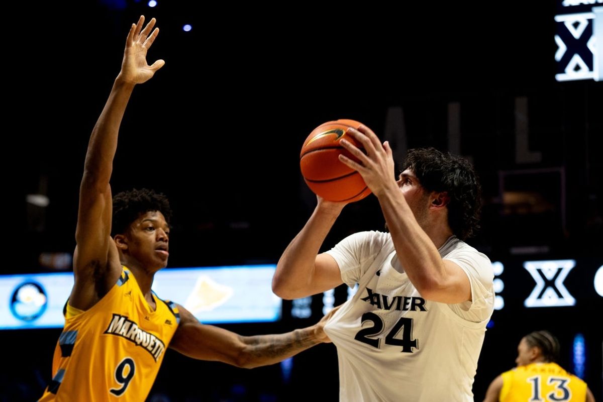 Xavier Musketeers forward Jovan Milicevic (24) hits a jump shot over Marquette Golden Eagles forward Damarius Owens (9) in the second half of the game at the Cintas Center in Cincinnati on Saturday, Feb. 14, 2026.