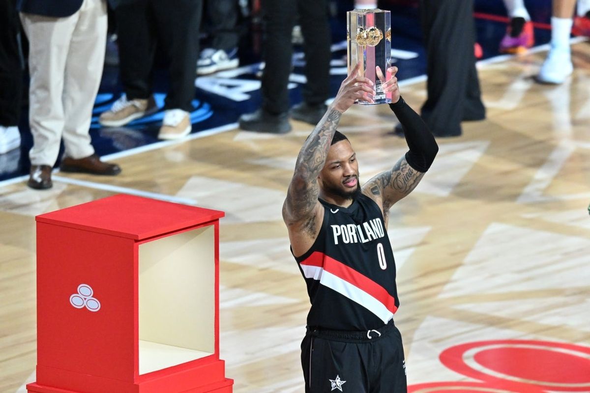 Feb 14, 2026; Los Angeles, CA, USA; Portland Trail Blazers guard Damian Lillard (0) celebrates with the trophy after winning the three point contest during the 2026 NBA All Star Saturday Night at Intuit Dome. Mandatory Credit: William Liang-Imagn Images