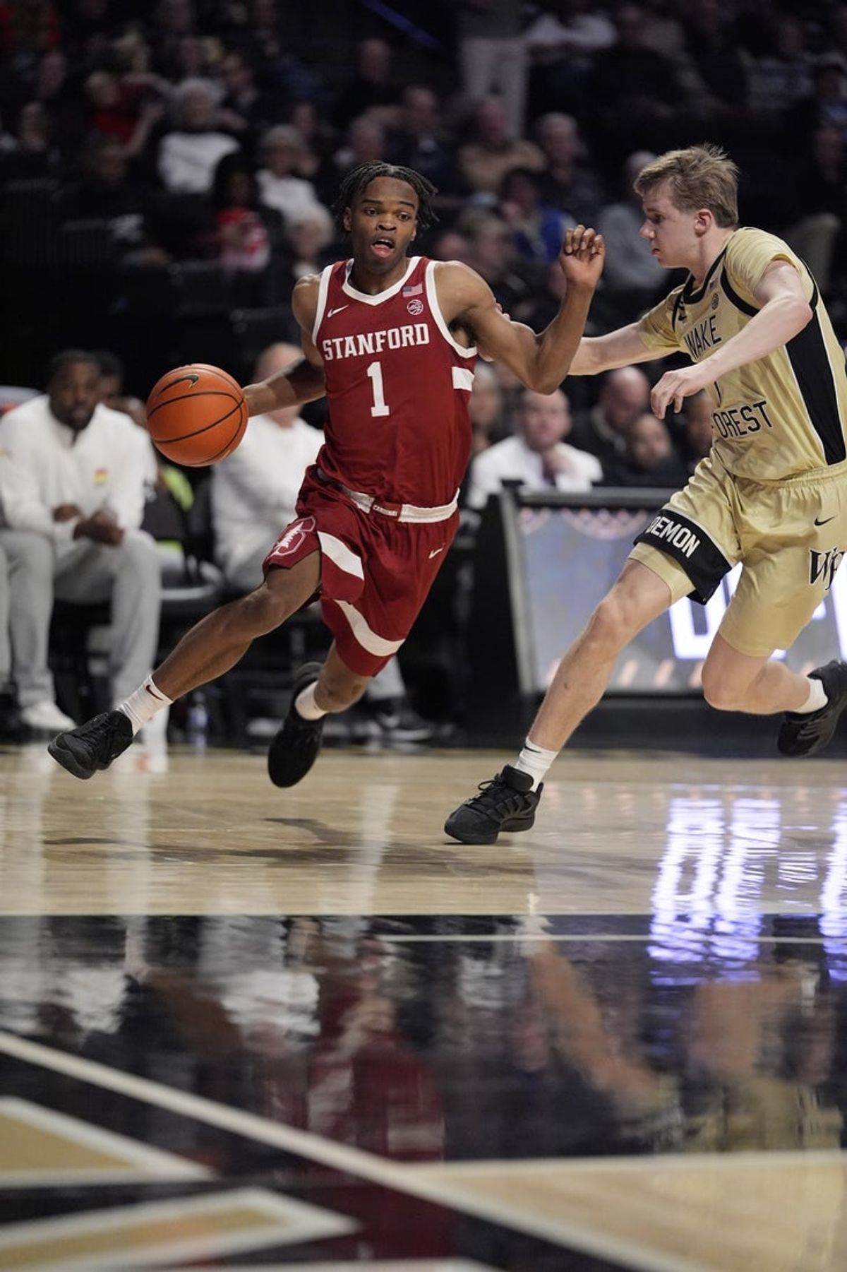 Feb 14, 2026; Winston-Salem, North Carolina, USA; Stanford Cardinal guard Ebuka Okorie (1) goes to the basket against Wake Forest Demon Deacons guard Isaac Carr (7) during the second half at Lawrence Joel Veterans Memorial Coliseum. Mandatory Credit: Jim Dedmon-Imagn Images