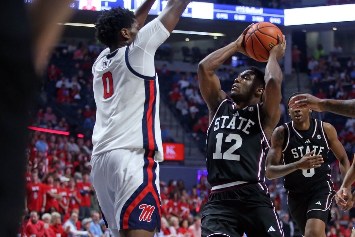 Feb 14, 2026; Oxford, Mississippi, USA; Mississippi State Bulldogs guard Josh Hubbard (12) drives to the basket as Mississippi Rebels forward Malik Dia (0) defends during the first half at The Sandy and John Black Pavilion at Ole Miss. Mandatory Credit: Petre Thomas-Imagn Images