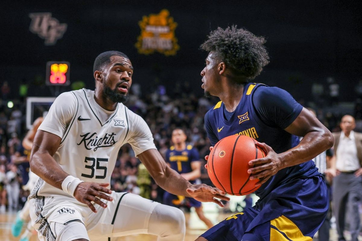 Feb 14, 2026; Orlando, Florida, USA; UCF Knights forward Devan Cambridge (35) defends West Virginia Mountaineers guard Honor Huff (3) during the first half at Addition Financial Arena. Mandatory Credit: Mike Watters-Imagn Images