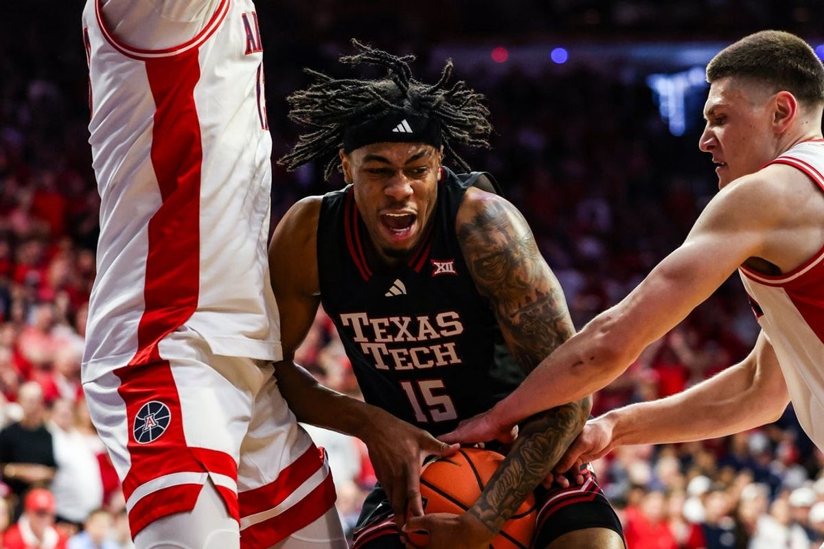 Feb 14, 2026; Tucson, Arizona, USA; Arizona Wildcats forward Ivan Kharchenkov (8) attempts to steal the ball from Texas Tech Red Raiders forward JT Toppin (15) during the first half of the game at McKale Memorial Center. Mandatory Credit: Aryanna Frank-Imagn Images