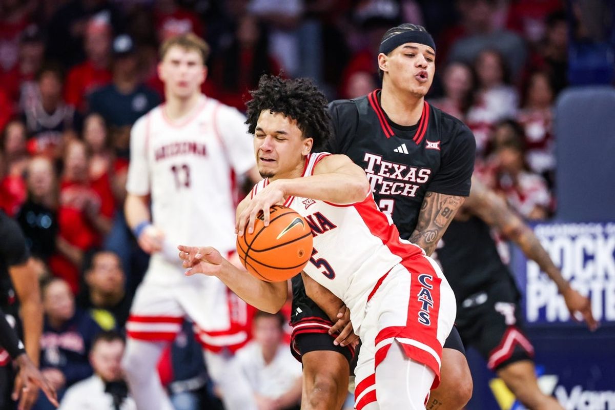 Feb 14, 2026; Tucson, Arizona, USA; Arizona Wildcats guard Brayden Burries (5) dribbles the ball while Texas Tech Red Raiders forward LeJuan Watts (3) attempts to block him during the first half of the game at McKale Memorial Center. Mandatory Credit: Aryanna Frank-Imagn Images