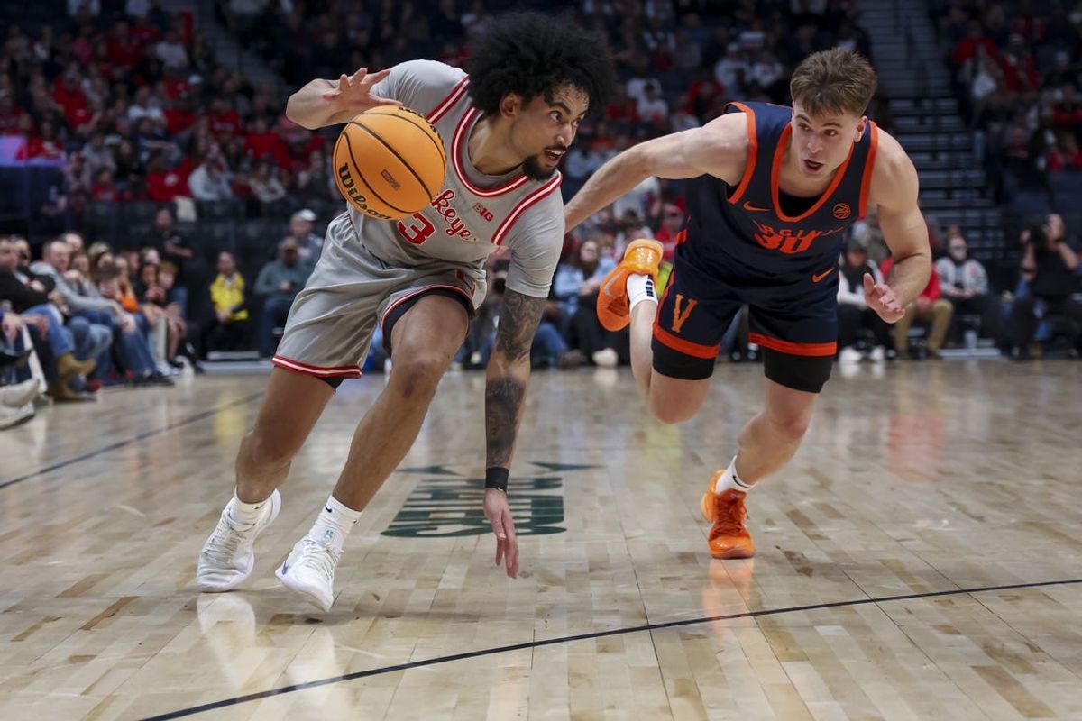 Feb 14, 2026; Nashville, Tennessee, USA;  Ohio State Buckeyes guard Taison Chatman (3) dribbles the ball past Virginia Cavaliers guard Dallin Hall (30) during the first half at Bridgestone Arena. Mandatory Credit: Steve Roberts-Imagn Images