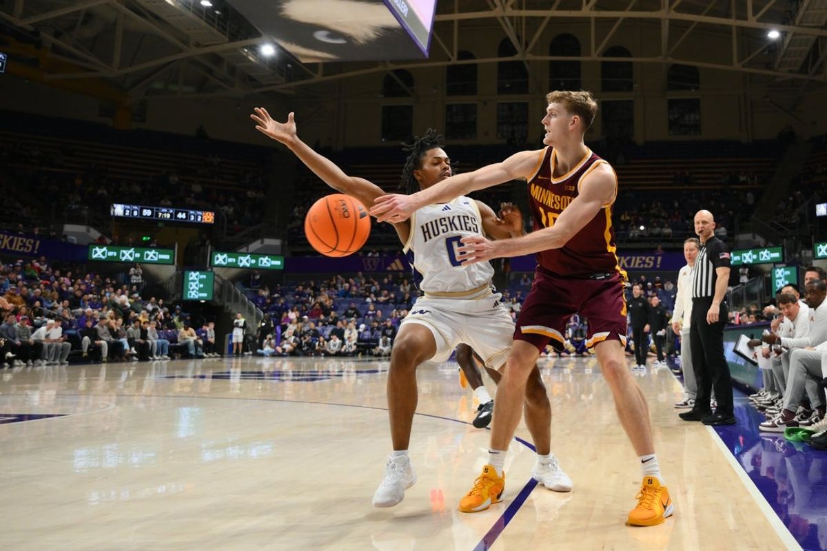 Feb 14, 2026; Seattle, Washington, USA; Minnesota Golden Gophers forward Cade Tyson (10) passes the ball while guarded by Washington Huskies guard Quimari Peterson (0) during the second half at Alaska Airlines Arena at Hec Edmundson Pavilion. Mandatory Credit: Steven Bisig-Imagn Images