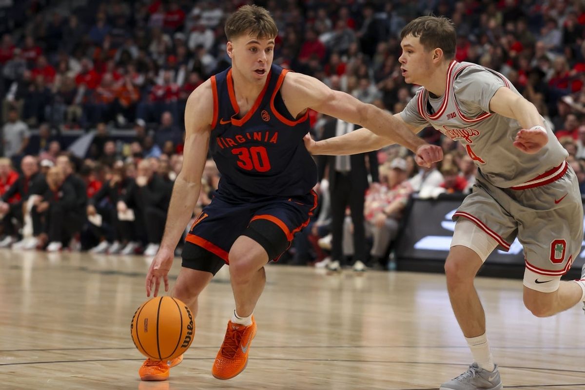 Feb 14, 2026; Nashville, Tennessee, USA;  Virginia Cavaliers guard Dallin Hall (30) dribbles the ball past Ohio State Buckeyes guard Gabe Cupps (4) during the second half at Bridgestone Arena. Mandatory Credit: Steve Roberts-Imagn Images