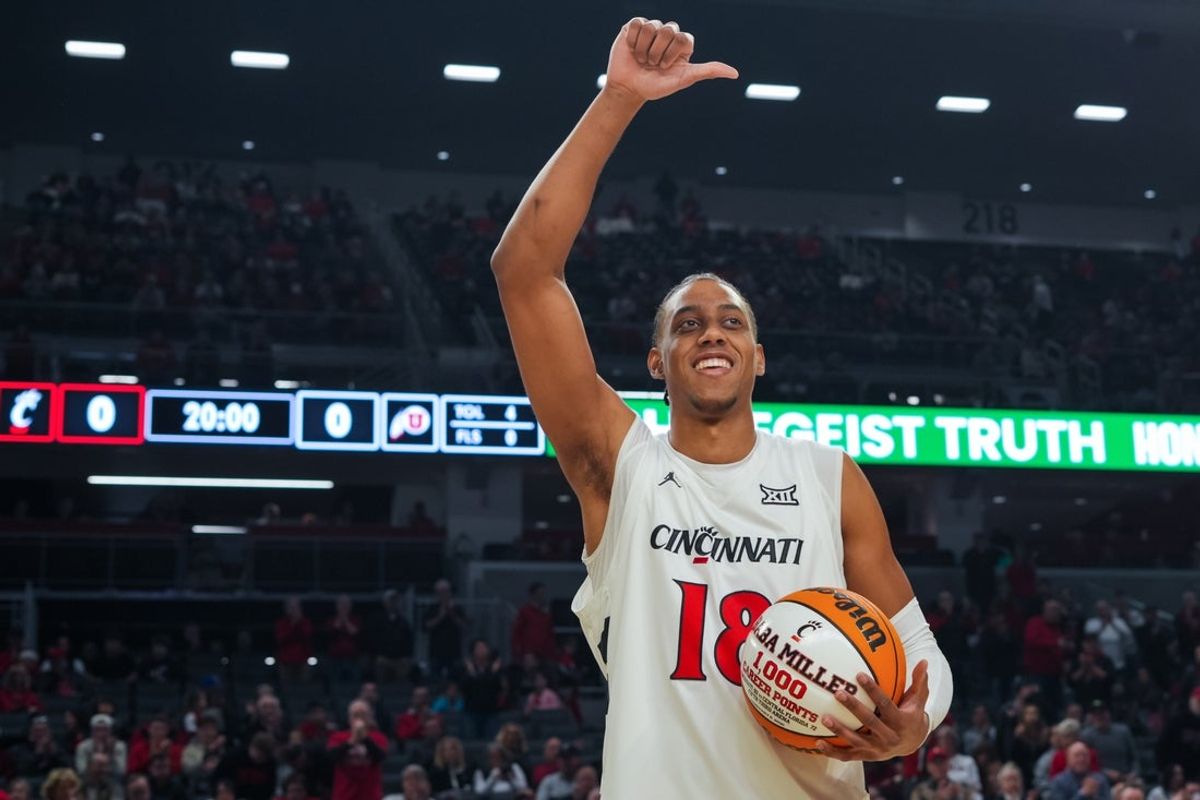 Feb 15, 2026; Cincinnati, Ohio, USA;  Cincinnati Bearcats forward Baba Miller is honored on the court for having 1,000 career points before the game against the Utah Utes at Fifth Third Arena. Mandatory Credit: Aaron Doster-Imagn Images
