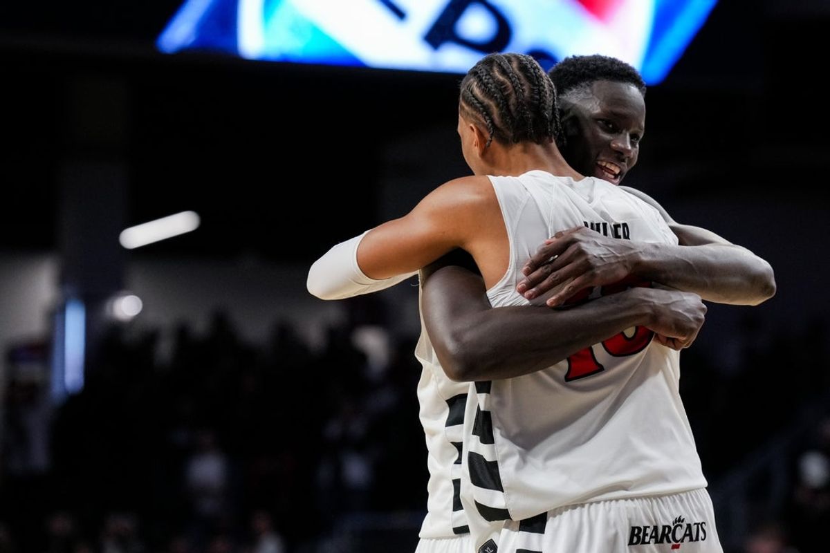 Feb 15, 2026; Cincinnati, Ohio, USA;  Cincinnati Bearcats center Moustapha Thiam, back, hugs forward Baba Miller after their team’s win against the Utah Utes at Fifth Third Arena. Mandatory Credit: Aaron Doster-Imagn Images