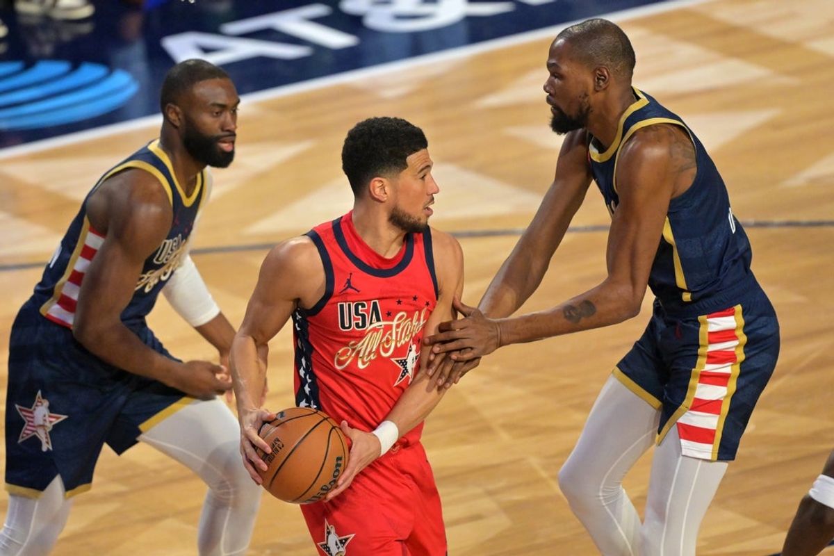 Feb 15, 2026; Inglewood, California, USA; Team USA Stars guard Devin Booker (1) of the Phoenix Suns controls the ball against Team USA Stripes forward Kevin Durant (35) of the Houston Rockets in game two during the 75th NBA All Star Game at Intuit Dome. Mandatory Credit: Jayne Kamin-Oncea-Imagn Images