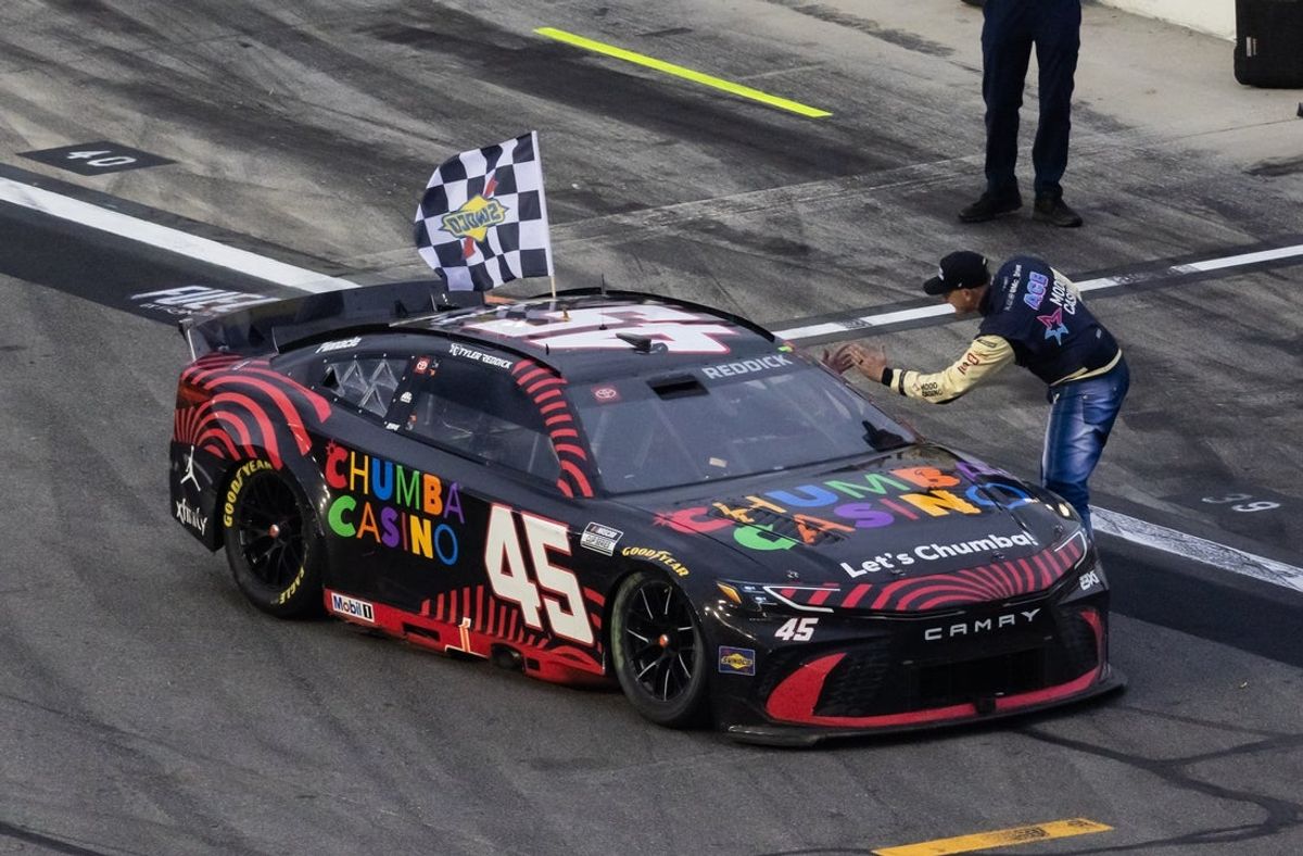 Feb 15, 2026; Daytona Beach, Florida, USA; NASCAR Cup Series driver Michael McDowell congratulates Tyler Reddick (45) on pit road after winning the 68th running of the Daytona 500 at Daytona International Speedway. Mandatory Credit: Mark J. Rebilas-Imagn Images