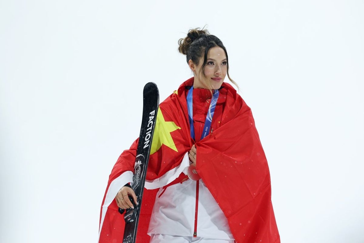 Feb 16, 2026; Livigno, Italy; Silver medalist Ailing Eileen Gu of the People's Republic of China looks on during the medal ceremony for the women's big air final during the Milano Cortina 2026 Olympic Winter Games at Livigno Snow Park. Mandatory Credit: Nathan Ray Seebeck-Imagn Images