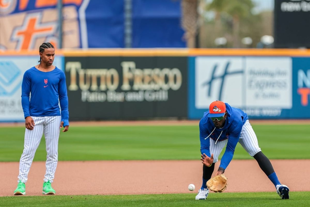 Feb 17, 2026; Port St. Lucie, FL, USA; New York Mets infielder Ronny Mauricio (0) catches a ground ball as infielder Francisco Lindor (12) watches during spring training at Clover Park. Mandatory Credit: Sam Navarro-Imagn Images
