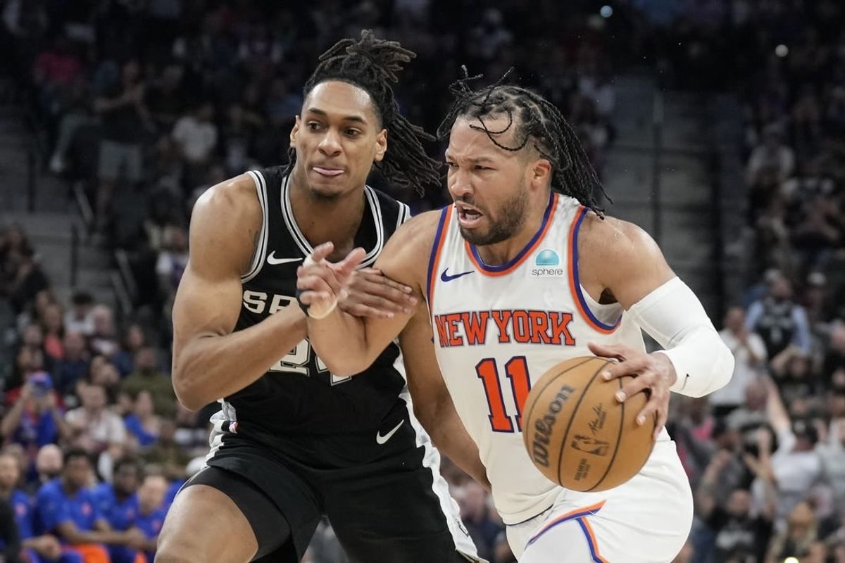 Mar 29, 2024; San Antonio, Texas, USA; New York Knicks guard Jalen Brunson (11) drives to the basket while defended by San Antonio Spurs guard Devin Vassell (24) during overtime at Frost Bank Center.