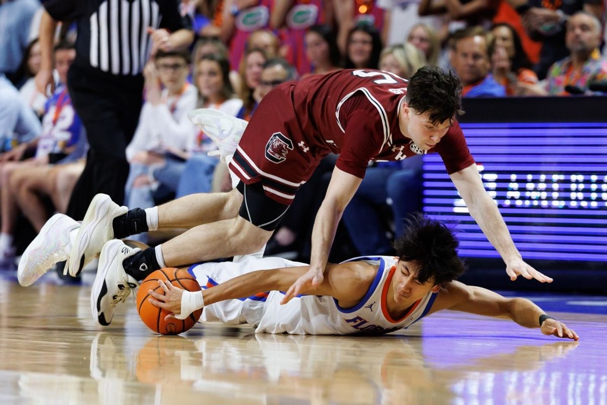Feb 17, 2026; Gainesville, Florida, USA; Florida Gators guard Xaivian Lee (1) and South Carolina Gamecocks guard Eli Ellis (15) battle for a loose ball during the first half at Exactech Arena at the Stephen C. O'Connell Center. Mandatory Credit: Matt Pendleton-Imagn Images