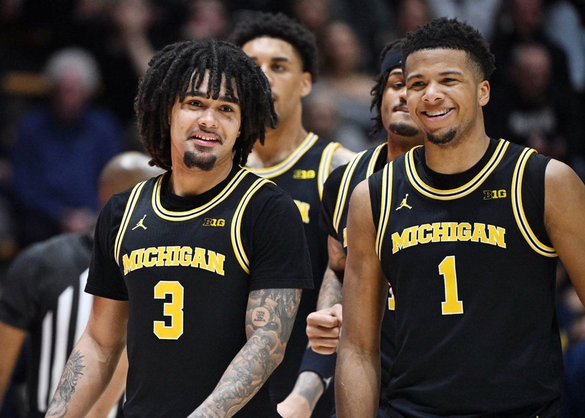 Feb 17, 2026; West Lafayette, Indiana, USA; Michigan Wolverines guard Elliot Cadeau (3) shares a moment with Michigan Wolverines guard Trey McKenney (1) during the second half against the Purdue Boilermakers at Mackey Arena. Mandatory Credit: Marc Lebryk-Imagn Images