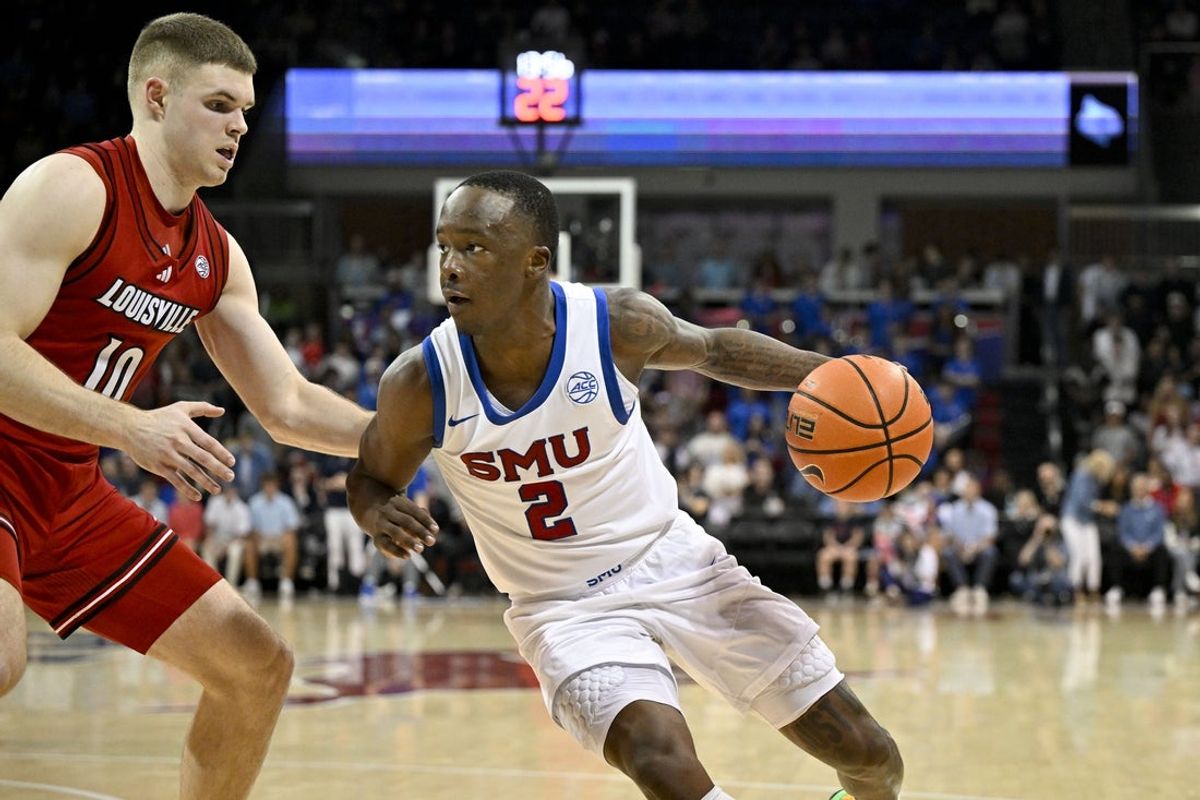 Feb 17, 2026; Dallas, Texas, USA; SMU Mustangs guard Boopie Miller (2) brings the ball up court past Louisville Cardinals guard Isaac McKneely (10) during the second half at Moody Coliseum. Mandatory Credit: Jerome Miron-Imagn Images