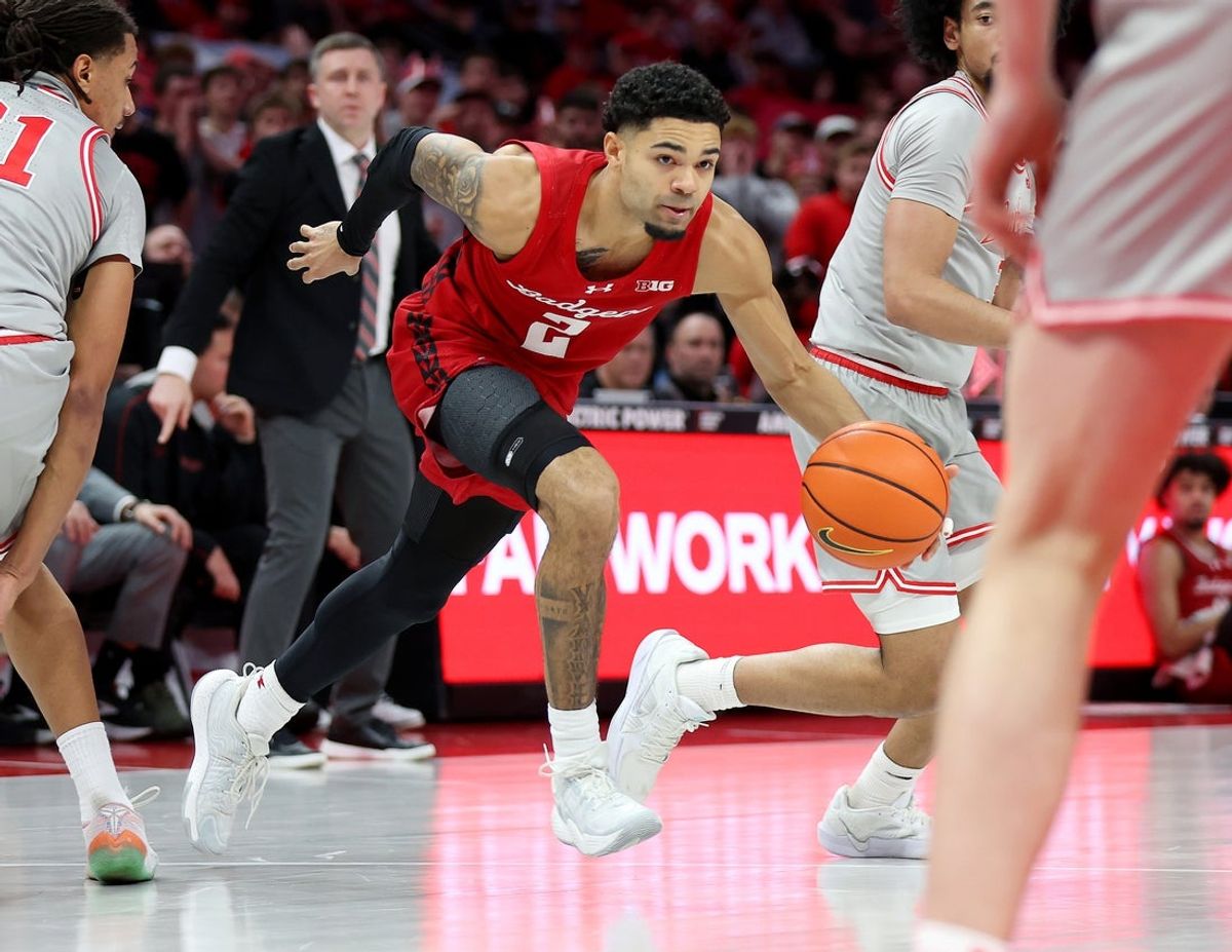 Feb 17, 2026; Columbus, Ohio, USA; Wisconsin Badgers guard Nick Boyd (2) dribbles the ball as Ohio State Buckeyes forward Devin Royal (21) defends during the first half at Value City Arena. Mandatory Credit: Joseph Maiorana-Imagn Images