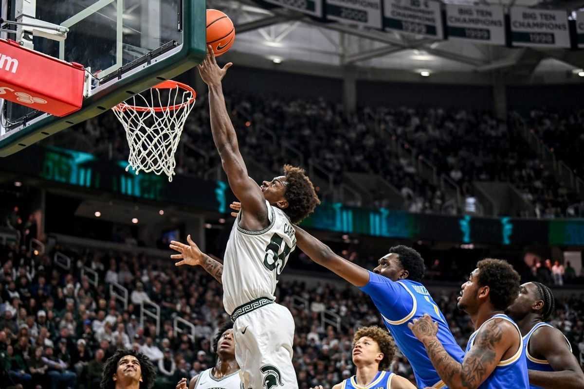 Michigan State's Coen Carr, left, scores against UCLA's Xavier Booker during the first half on Tuesday, Feb. 17, 2026, at the Breslin Center in East Lansing.