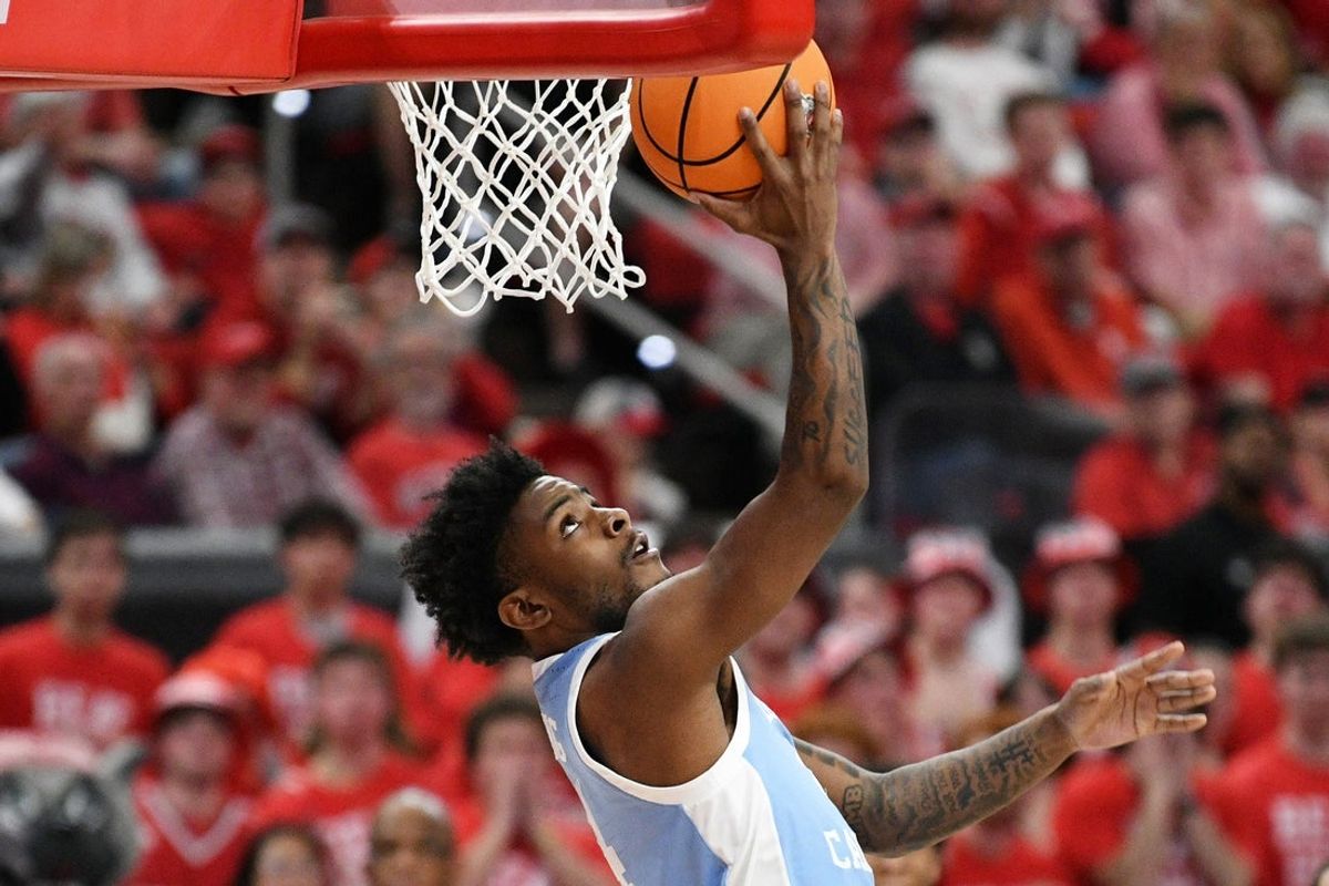 Feb 17, 2026; Raleigh, North Carolina, USA;  North Carolina Tar Heels guard Jaydon Young (4) lays the ball up for a basket against the NC State Wolfpack during the second half at Lenovo Center. Mandatory Credit: Zachary Taft-Imagn Images