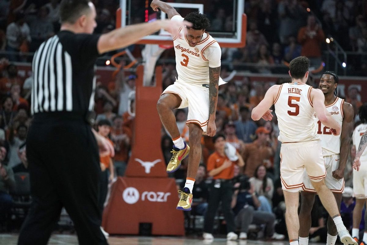 Feb 17, 2026; Austin, Texas, USA; Texas Longhorns guard Dailyn Swain (3) celebrates a three point basket by forward Camden Heide (5) for a during the first half against the LSU Tigers at Moody Center. Mandatory Credit: Dustin Safranek-Imagn Images