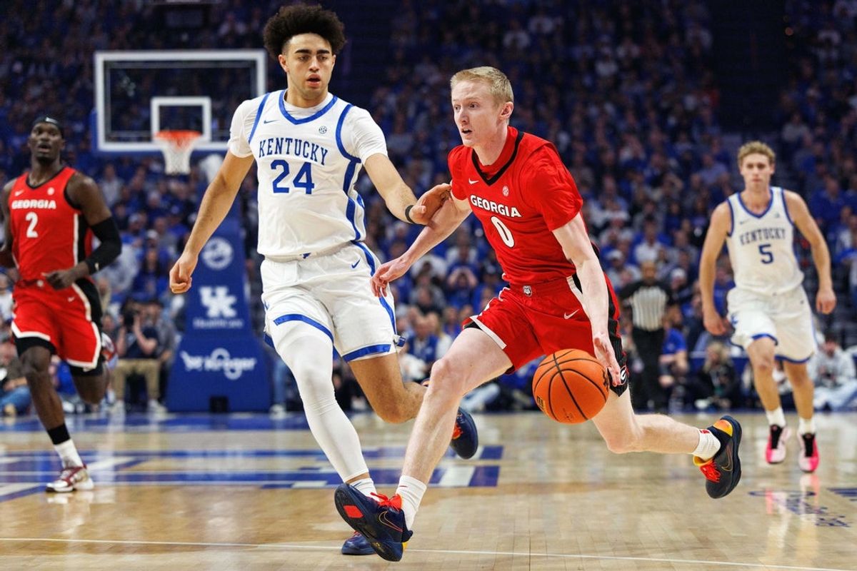 Feb 17, 2026; Lexington, Kentucky, USA; Georgia Bulldogs guard Blue Cain (0) drives to the basket around Kentucky Wildcats center Malachi Moreno (24) during the first half at Rupp Arena at Central Bank Center. Mandatory Credit: Jordan Prather-Imagn Images