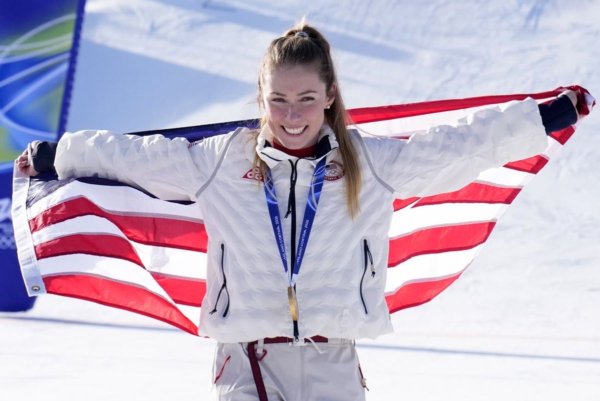 Feb 18, 2026; Cortina d'Ampezzo, Italy; Gold medalist Mikaela Shiffrin of the United States celebrates during the medal ceremony for the women's slalom during the Milano Cortina 2026 Olympic Winter Games at Tofane Alpine Skiing Centre. Mandatory Credit: Michael Madrid-Imagn Images