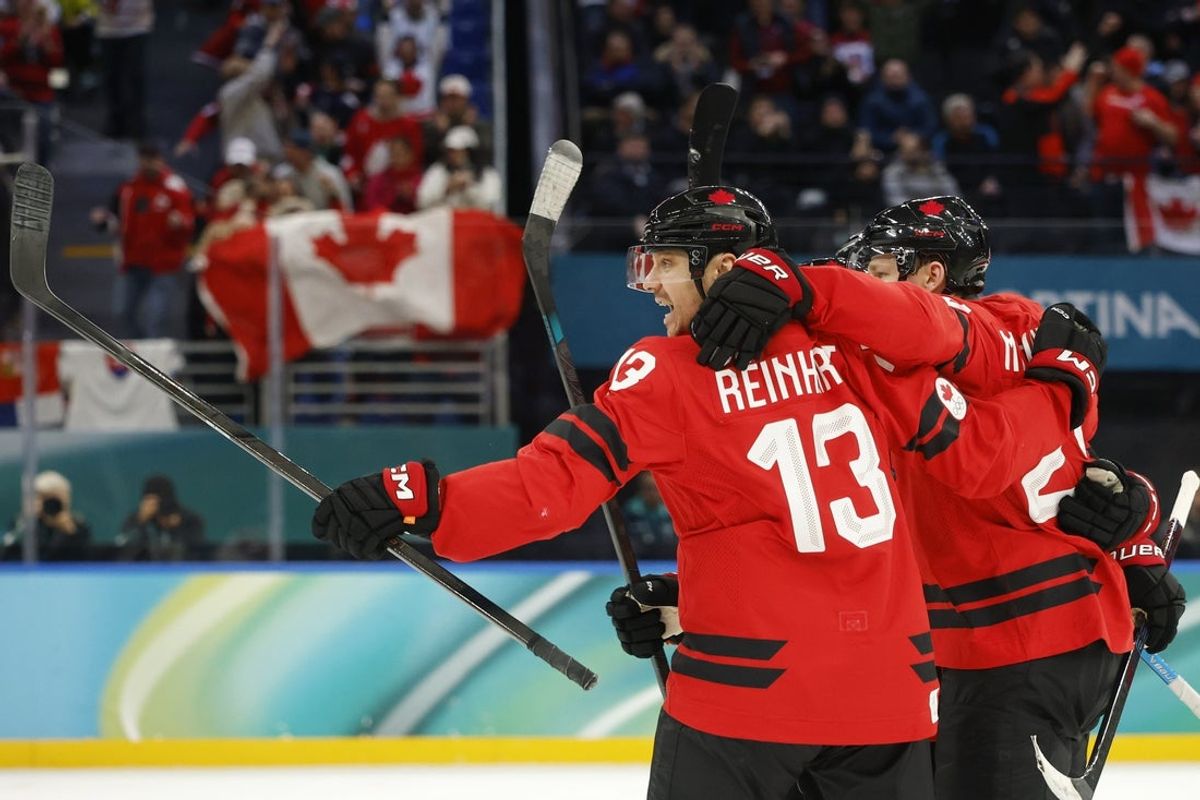 Sam Reinhart of Canada celebrates their goal scored by Nathan MacKinnon in a men's ice hockey quarterfinal during the Milano Cortina 2026 Olympic Winter Games at Milano Santagiulia Ice Hockey Arena. Mandatory Credit: Geoff Burke-Imagn Images