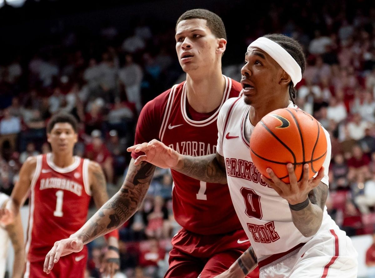 Feb 18, 2026; Tuscaloosa, AL, USA; Alabama guard Labaron Philon Jr. (0) drives past Arkansas forward Trevon Brazile (7) for a shot at Coleman Coliseum. Mandatory Credit: Gary Cosby Jr.-Tuscaloosa News