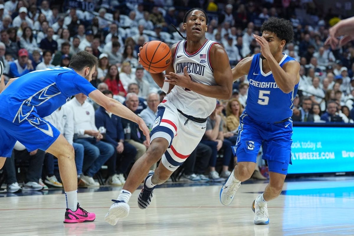 Feb 18, 2026; Storrs, Connecticut, USA; UConn Huskies guard Silas Demary Jr. (2) drives the ball against Creighton Bluejays guard Nik Graves (5) and guard Fedor Žugic (7) in the first half at Harry A. Gampel Pavilion. Mandatory Credit: David Butler II-Imagn Images