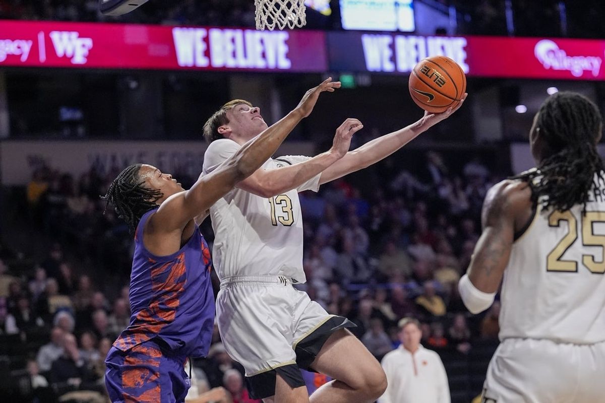 Feb 18, 2026; Winston-Salem, North Carolina, USA; Clemson Tigers guard Dillon Hunter (2) defends as Wake Forest Demon Deacons forward Cooper Schwieger (13) drives to the basket during the first half at Lawrence Joel Veterans Memorial Coliseum. Jim Dedmon