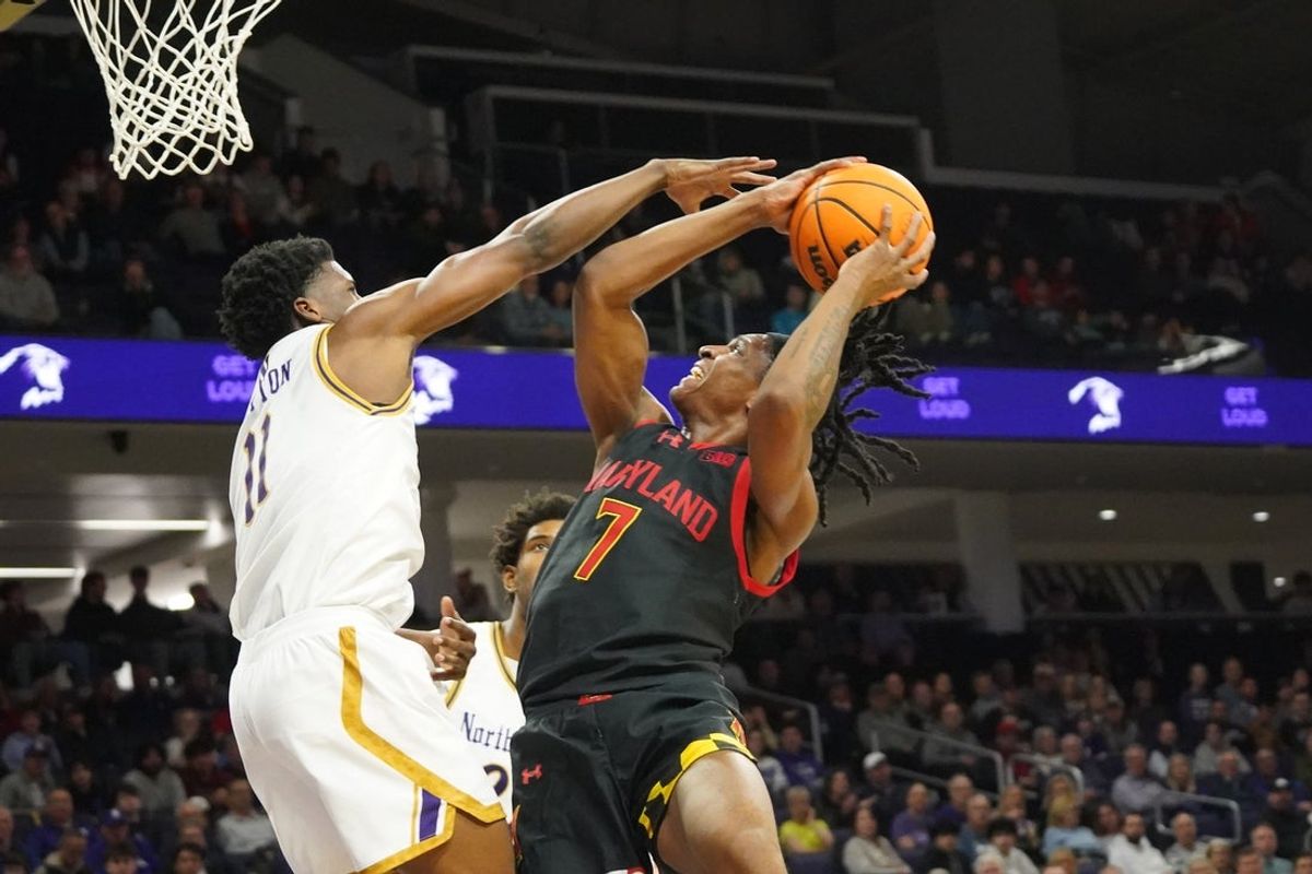 Feb 18, 2026; Evanston, Illinois, USA; Northwestern Wildcats guard Jordan Clayton (11) defends Maryland Terrapins guard Andre Mills (7) during the first half at Welsh-Ryan Arena. Mandatory Credit: David Banks-Imagn Images