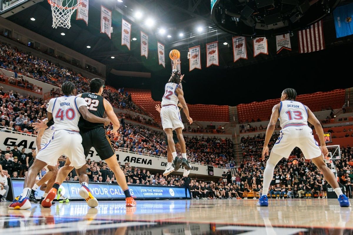 Feb 18, 2026; Stillwater, Oklahoma, USA; Kansas Jayhawks guard Darryn Peterson (22) blocks a shot by Oklahoma State Cowboys guard Anthony Roy (9) during the first half at Gallagher-Iba Arena. Mandatory Credit: William Purnell-Imagn Images