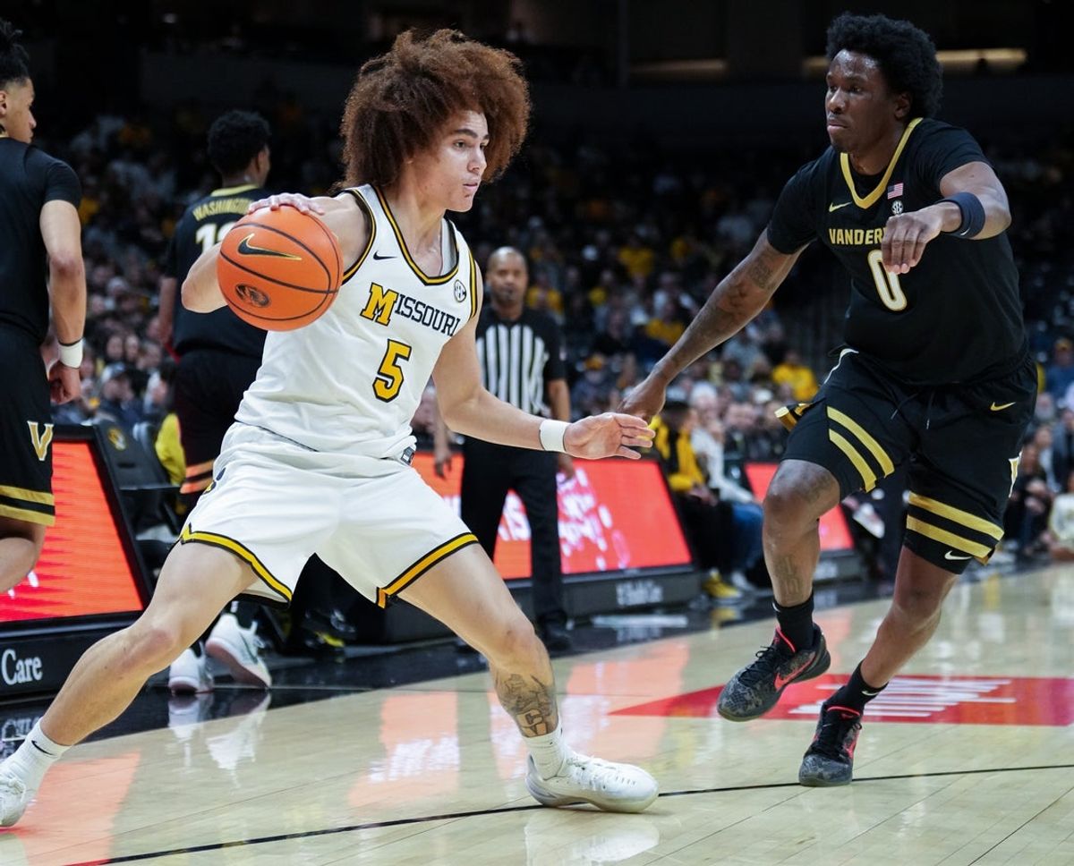 Feb 18, 2026; Columbia, Missouri, USA; Missouri Tigers guard T.O. Barrett (5) dribbles the ball as Vanderbilt Commodores guard Mike James (0) defends during the first half of the game at Mizzou Arena. Mandatory Credit: Denny Medley-Imagn Images
