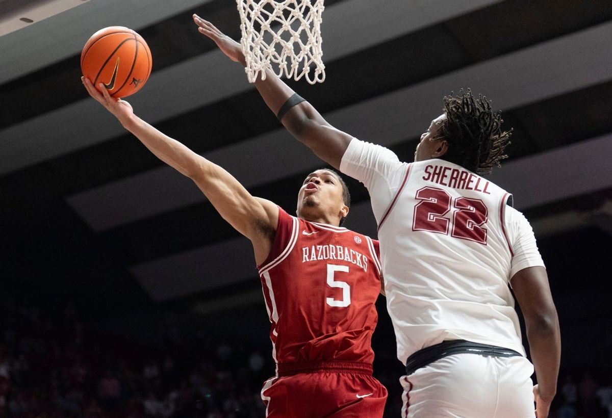 Feb 18, 2026; Tuscaloosa, AL, USA; Arkansas guard Darius Acuff Jr. (5) scores inside against Alabama forward Aiden Sherrell (22) at Coleman Coliseum. Alabama defeated Arkansas 117-115 in double overtime. Acuff Jr. led all scorers with a career high of 49 points. Mandatory Credit: Gary Cosby Jr.-Tuscaloosa News