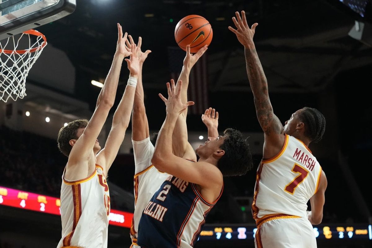 Feb 18, 2026; Los Angeles, California, USA; Illinois Fighting Illini guard Andrej Stojakovic (2) shoots the ball against Southern California Trojans center Gabe Dynes (45), guard Cam Woods (13) and guard Jordan Marsh (7) in the first half at Galen Center. Mandatory Credit: Kirby Lee-Imagn Images