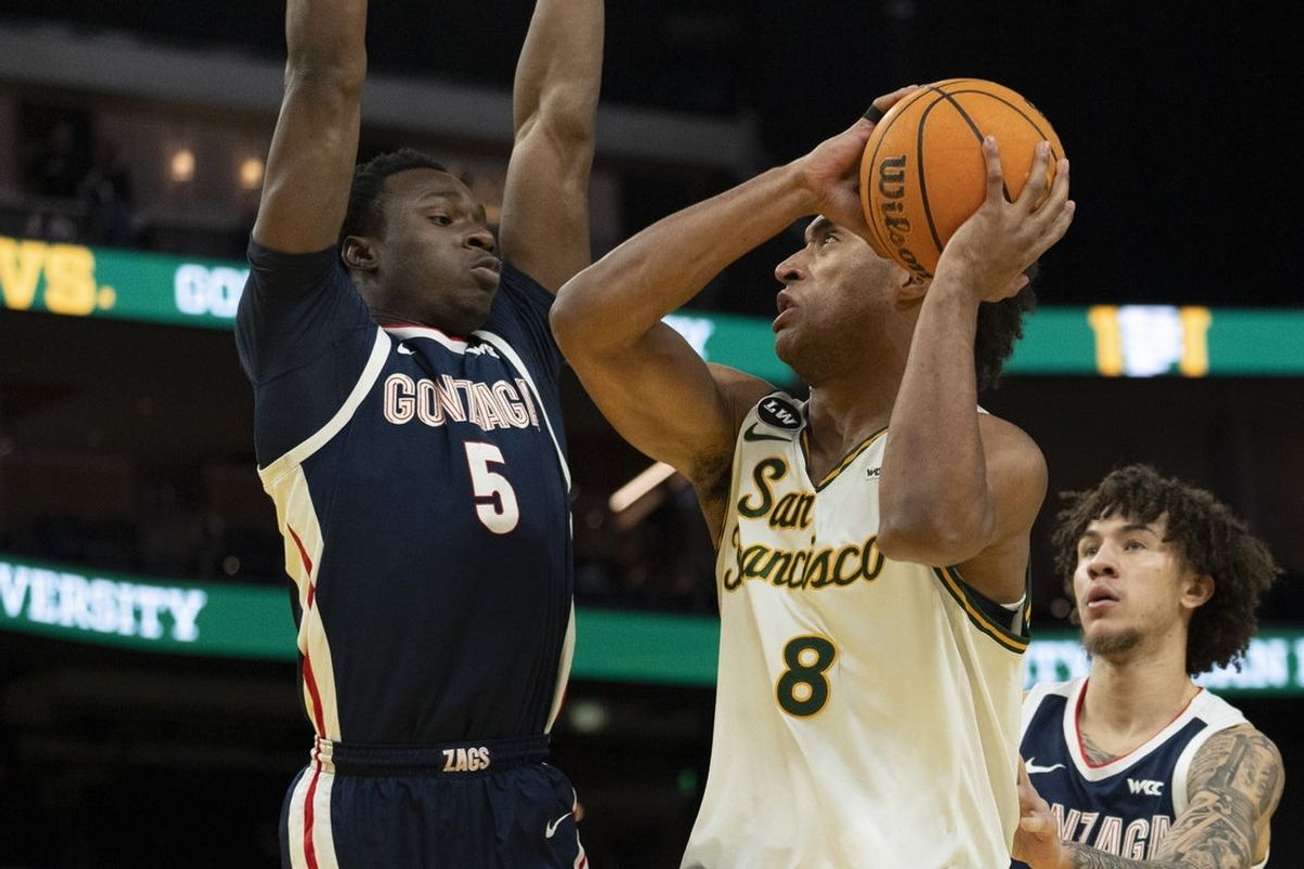 Feb 18, 2026; San Francisco, California, USA;  Gonzaga Bulldogs forward Emmanuel Innocenti (5) defends against San Francisco Dons forward David Fuchs (8) during the first half at Chase Center. Mandatory Credit: Stan Szeto-Imagn Images