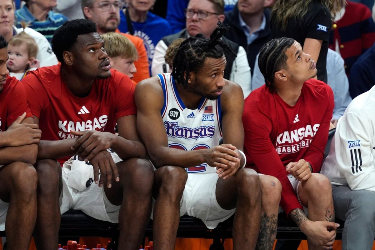 Kansas Jayhawks guard Darryn Peterson (22) sits on the bench in the second half of a men's college basketball game between the Oklahoma State Cowboys and the Kansas Jayhawks at Gallagher-Iba Arena in Stillwater, Okla., Wednesday, Feb. 18, 2026.
